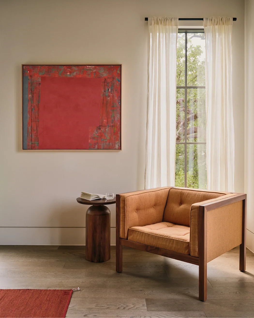 Modern dining area with wooden table, four chairs, decorative vase, and abstract wall art.