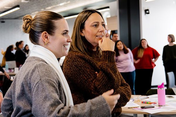Two educators in conversation at a professional learning session
