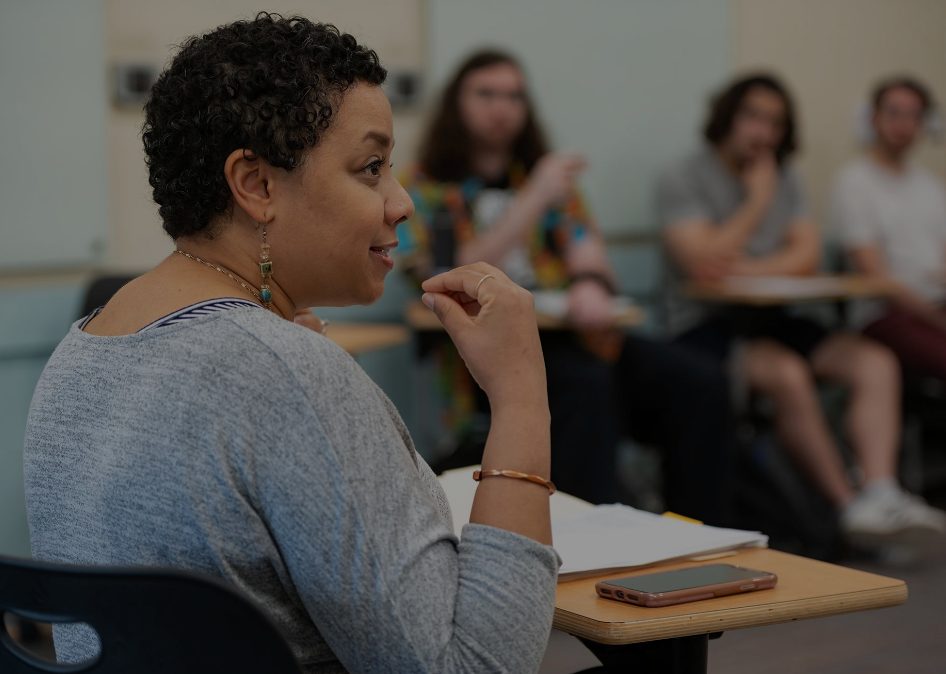 Facilitator speaking to a small group in a seminar room