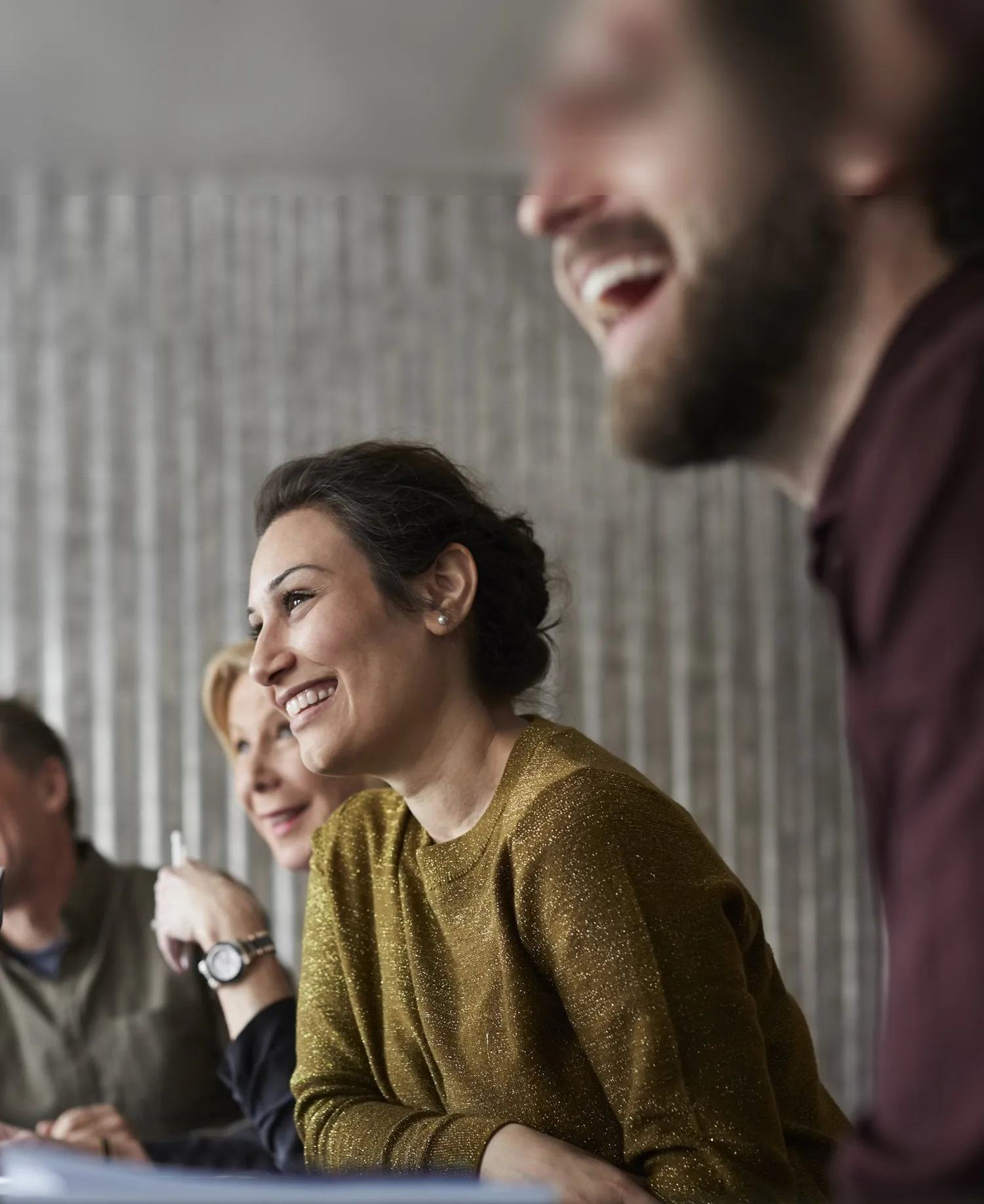 Leaders listening and smiling together during a discussion