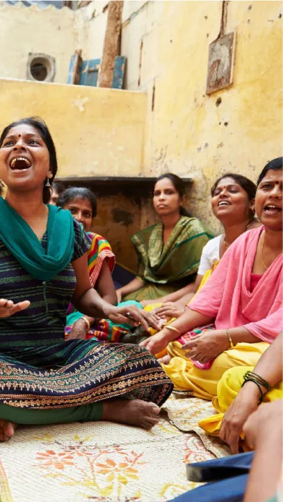 A group of women sitting down laughing