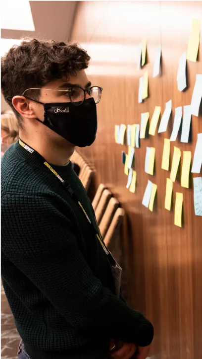 Person looking at sticky notes on a wall