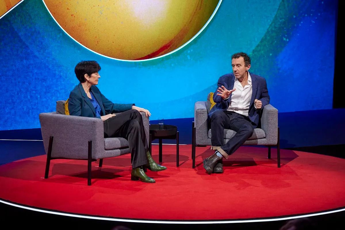 Two people talking on the TED stage