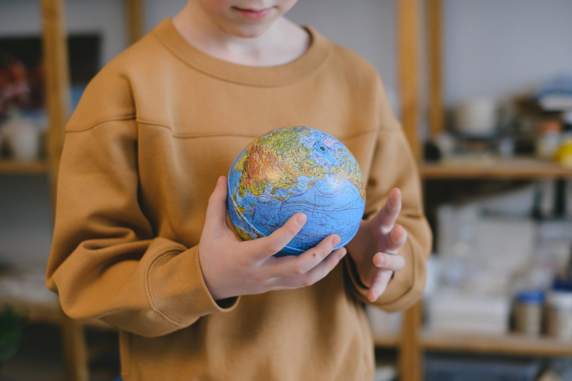 boy holding a globe.