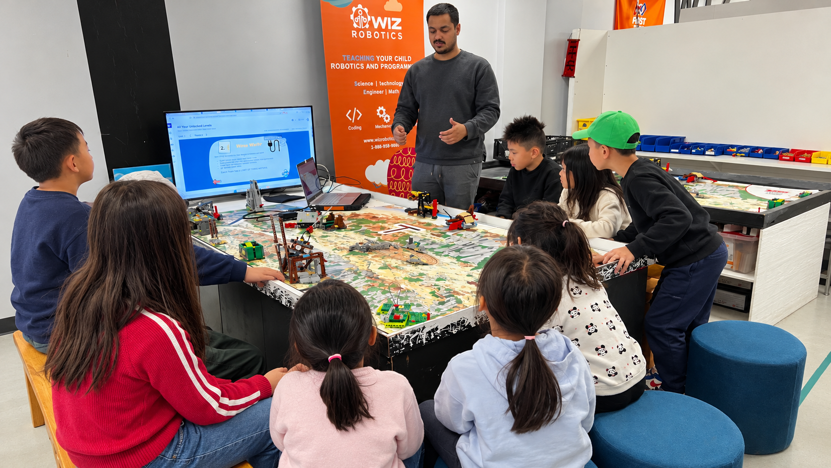 Children working together on a LEGO robot at Wiz Robotics.