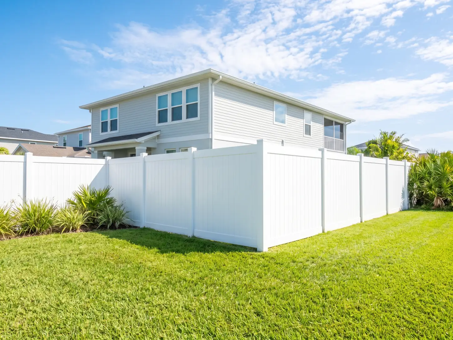 Pristine white vinyl privacy fence around a modern Gulf Coast backyard