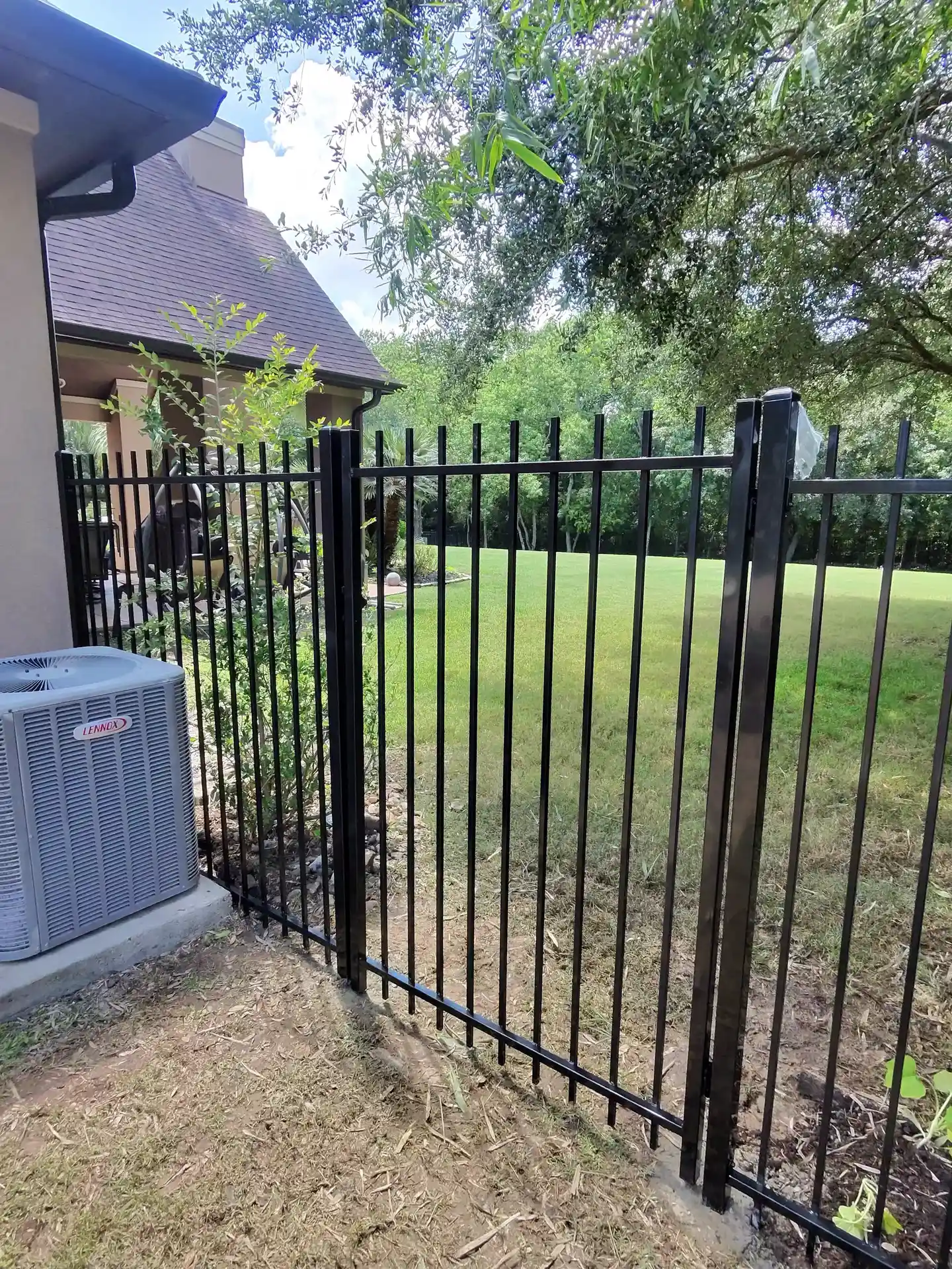 Black ornamental iron fence and gate installed by Fast Eddie's Fast Fences in Friendswood, TX