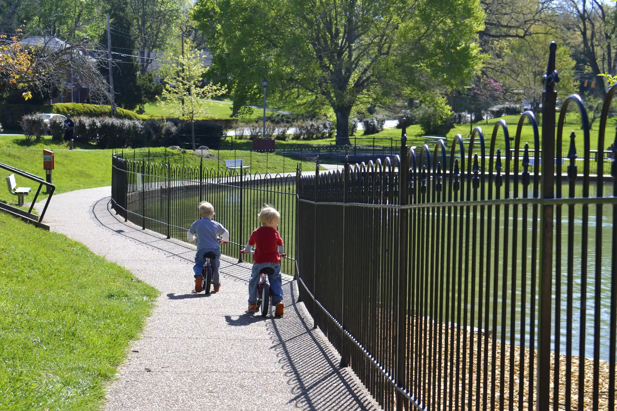 Black metal fence along a park path