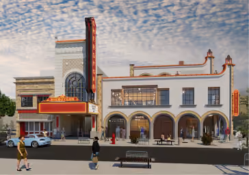 A vintage-style theater building with a marquee and a vertical sign reading 'Jordan' against a cloudy sky.