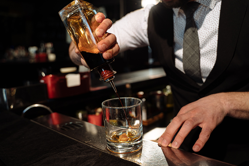 A bartender preparing a cocktail.