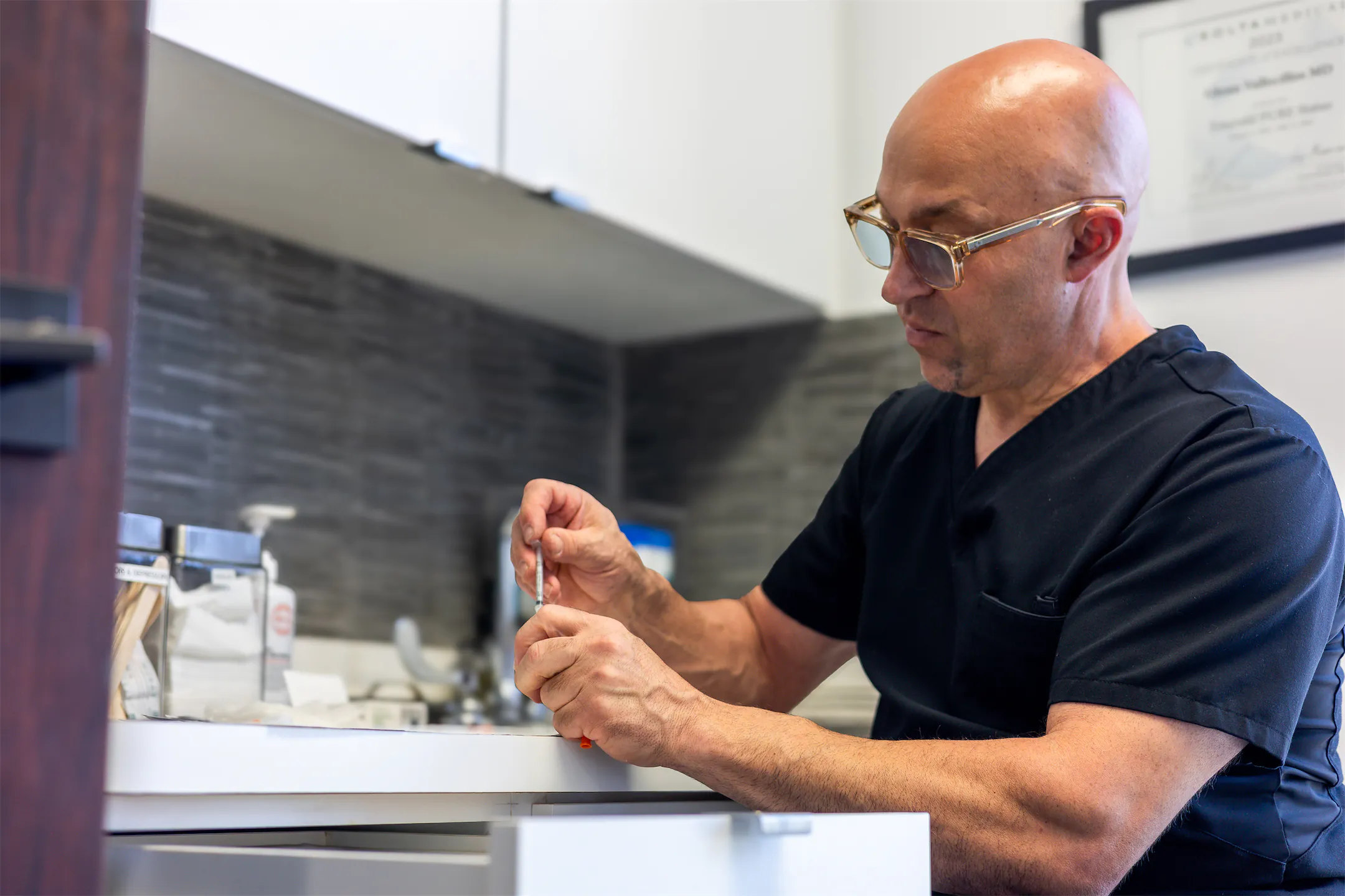 Dr. Vallecillos preparing a treatment at the counter in his office