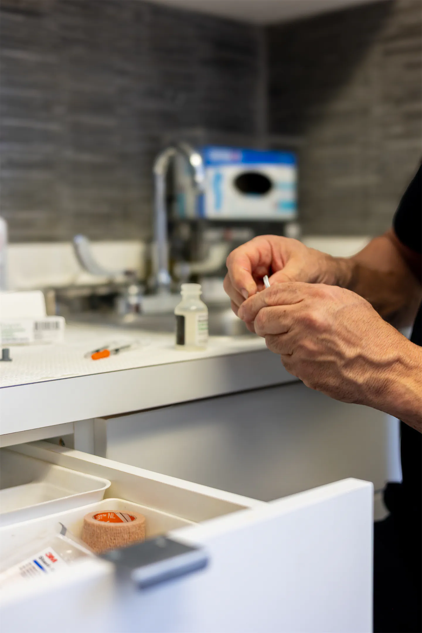 Dr. Vallecillos preparing supplies at the treatment-room counter