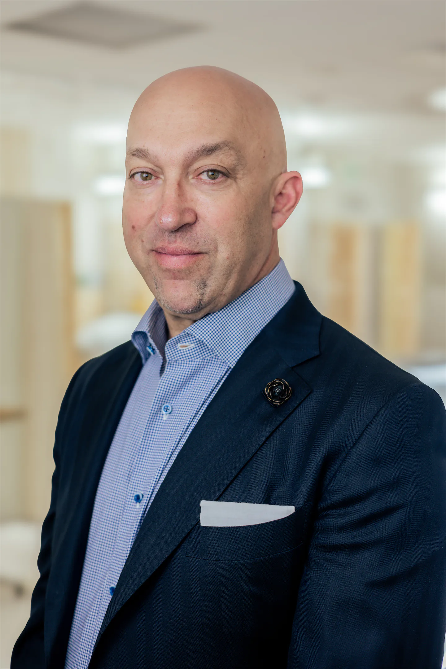 Portrait of Dr. Vallecillos in a navy blazer in the office