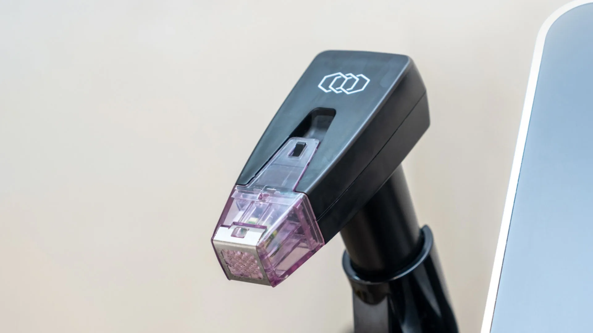 Radiofrequency microneedling handpiece resting in its holder