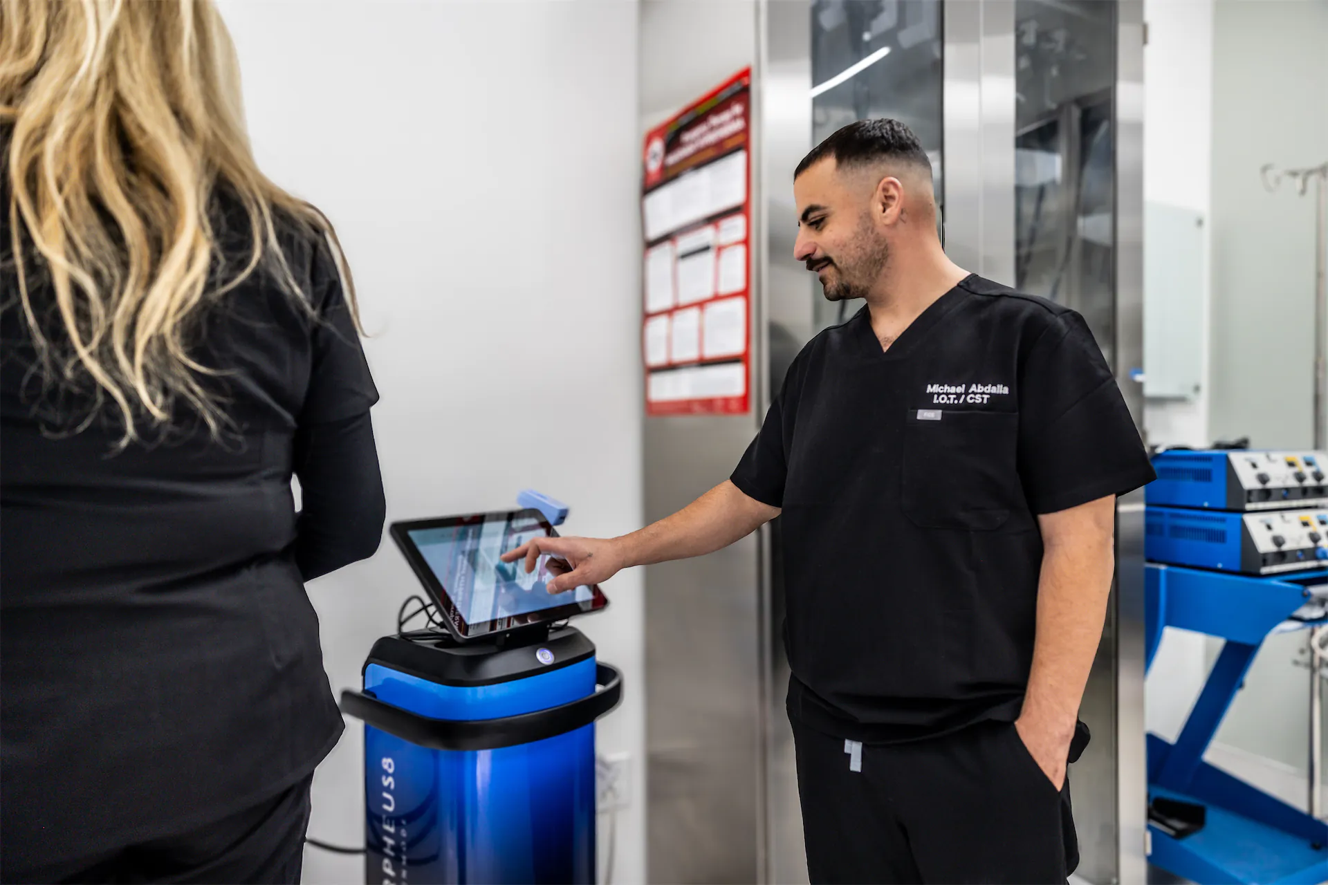 Michael Abdalla, I.O.T./CST, setting up a Morpheus8 device on its touchscreen beside a colleague