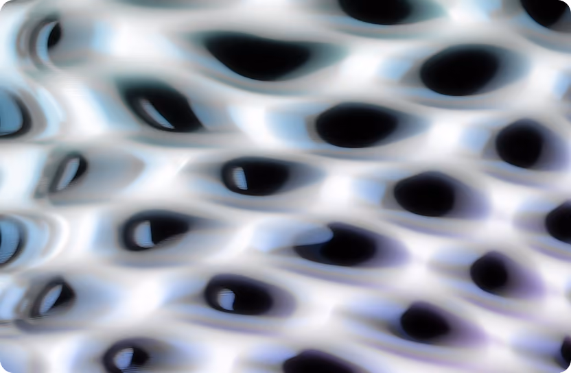 Abstract close-up of a translucent surface with black elliptical shapes and soft blue reflections.