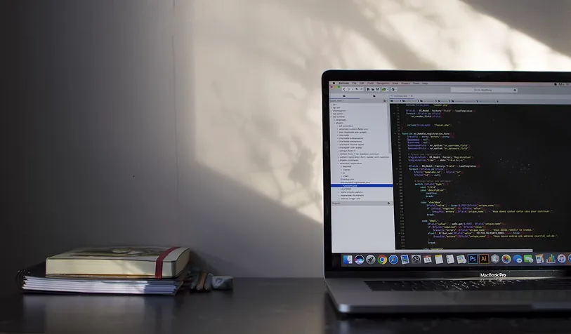 A laptop showing code on a desk