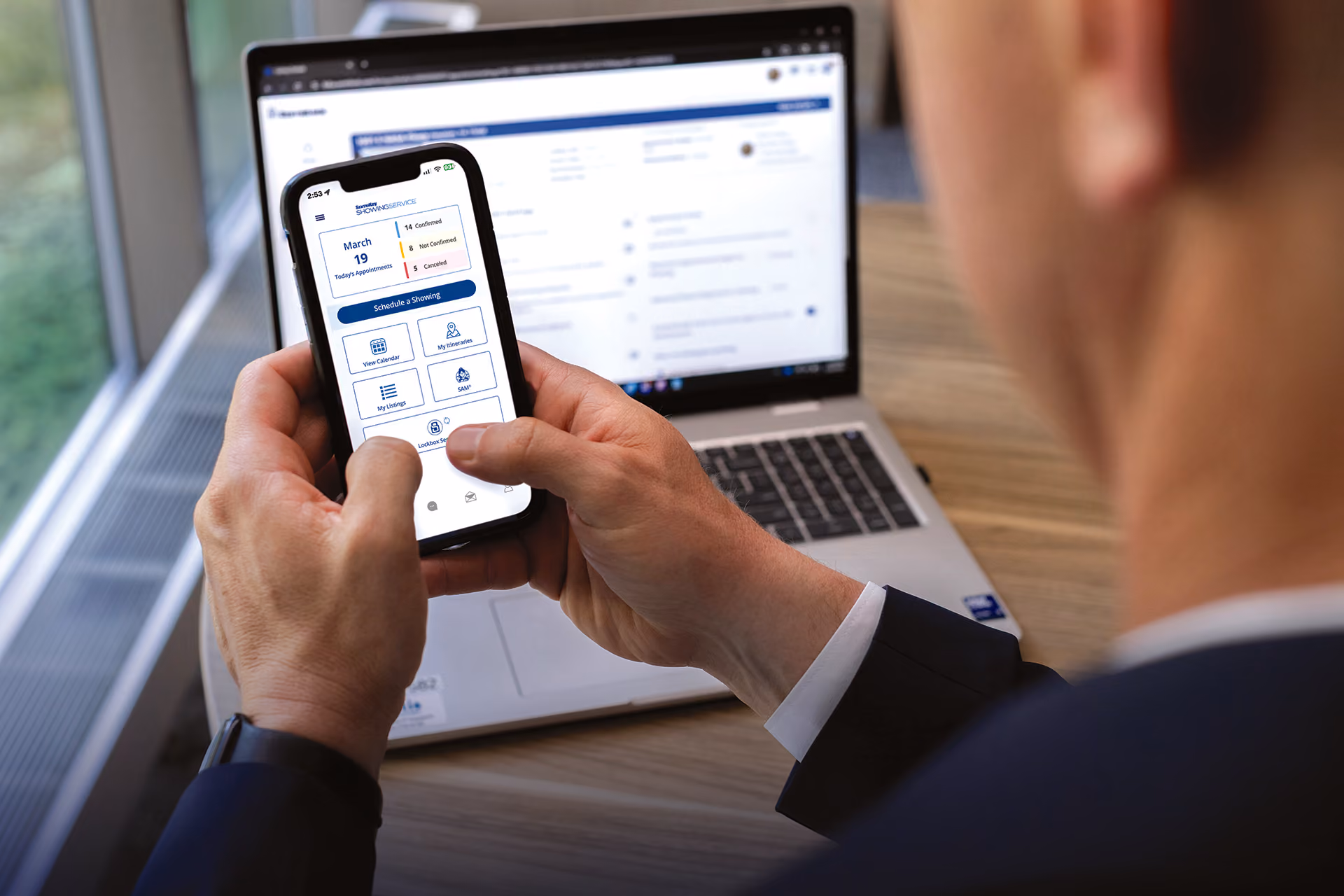 A real estate agent using the SentriKey Real Estate app on their smartphone.