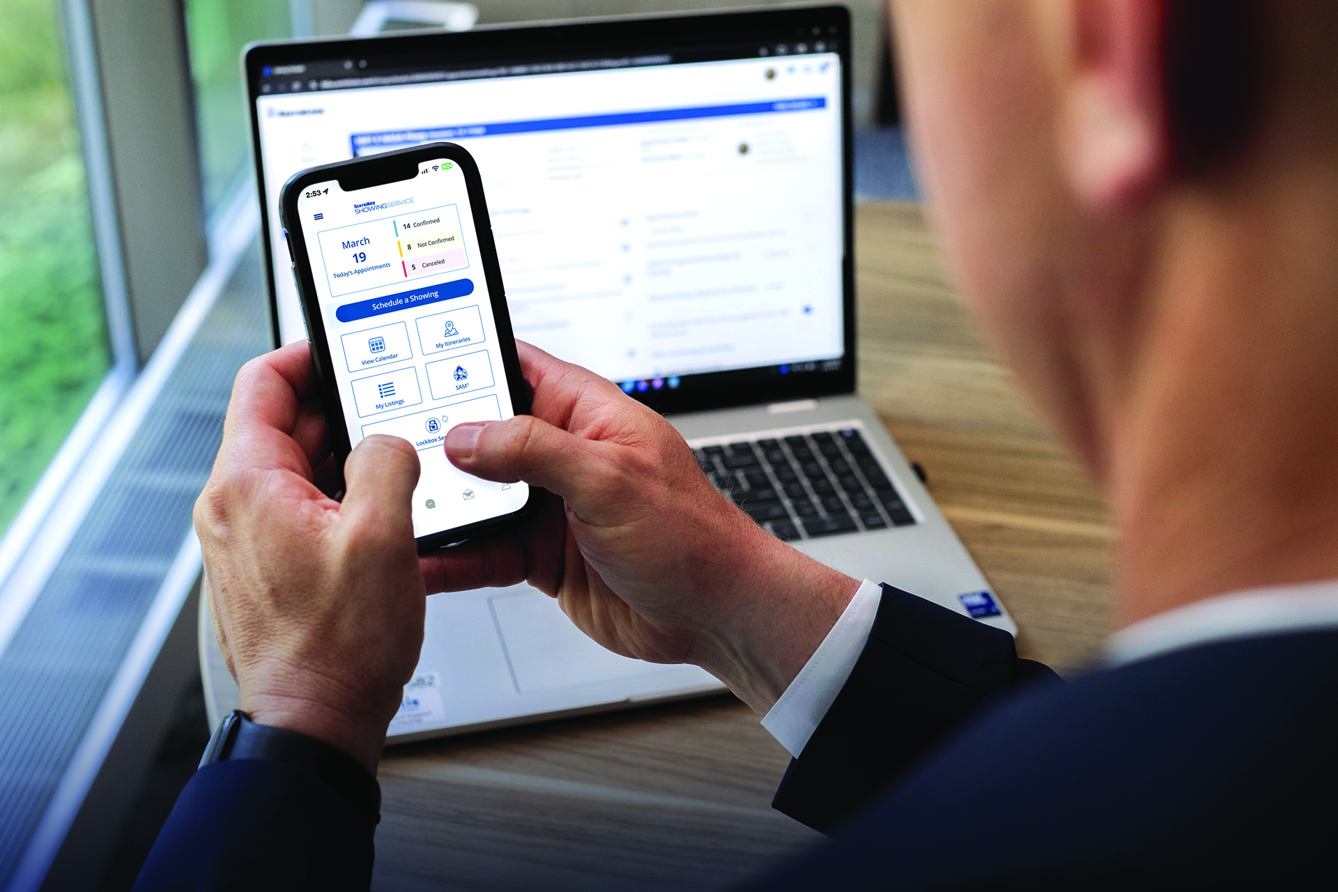 A real estate agent using the SentriKey Real Estate app on their smartphone.