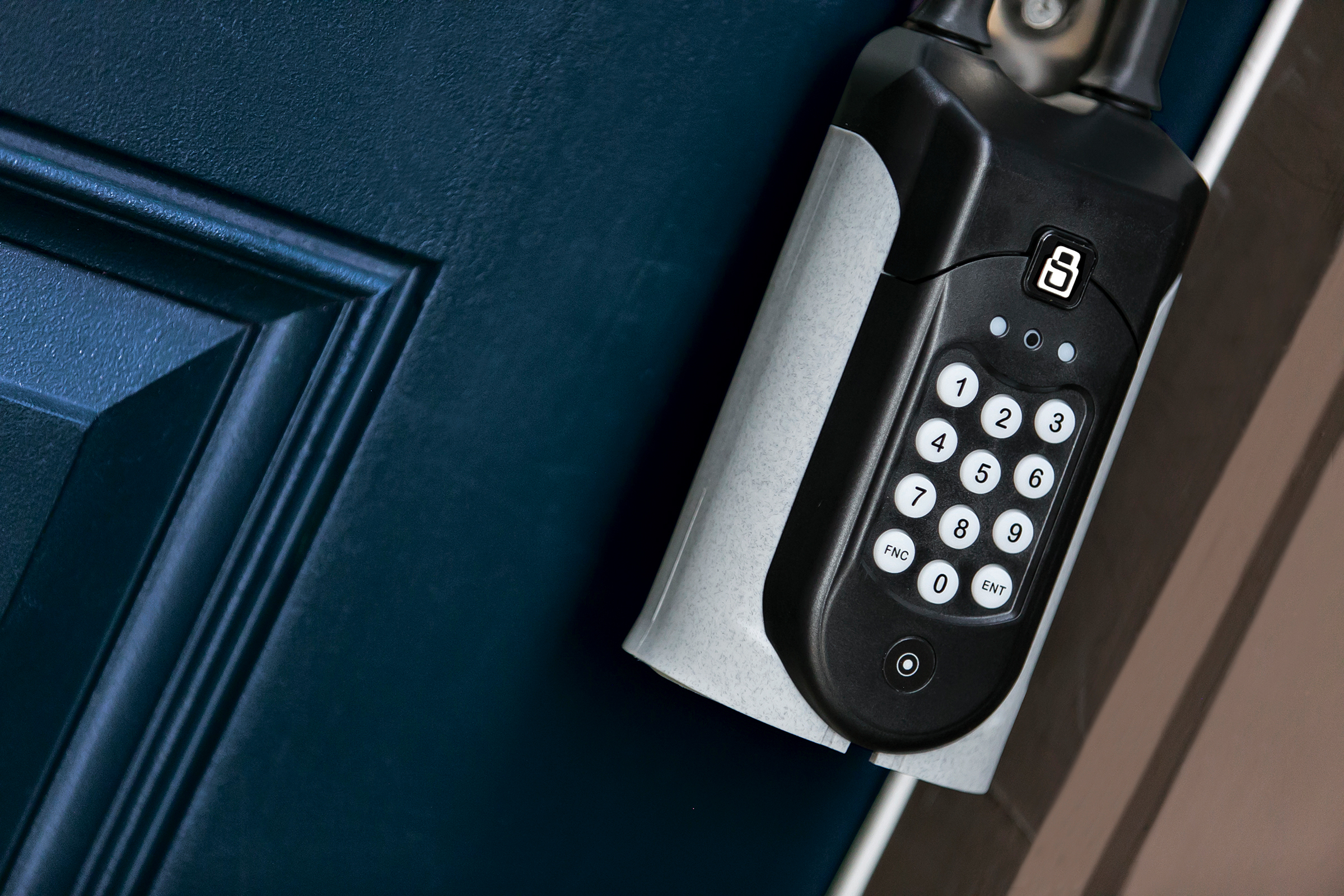 A SentriGuard lockbox mounted to a door handle in a wide shot.
