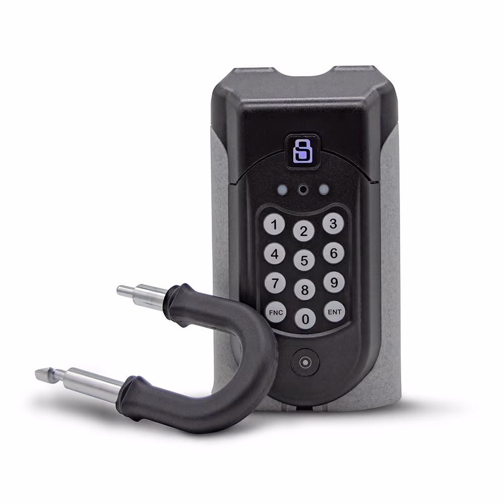 A SentriGuard lockbox with the shackle released, resting on the side.
