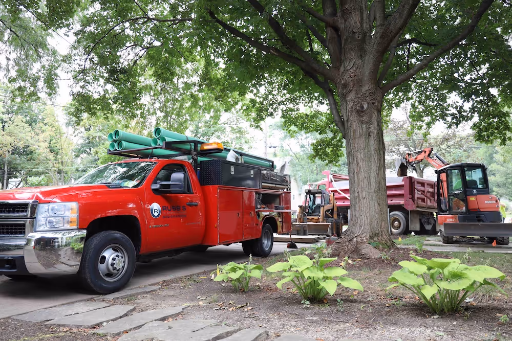 russ-plumbing-red-truck-on-jobsite-in-glen-ellyn