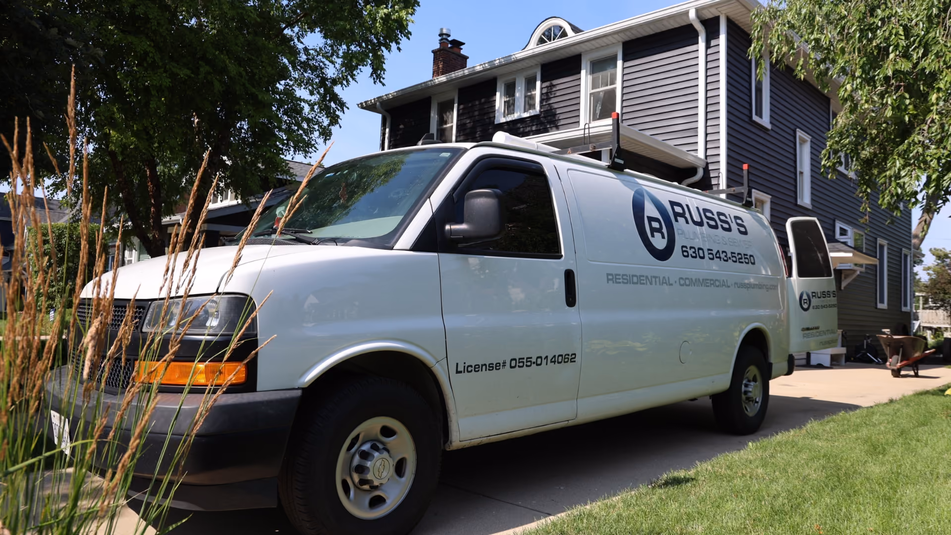 russ-plumbing-white-service-van-on-jobsite