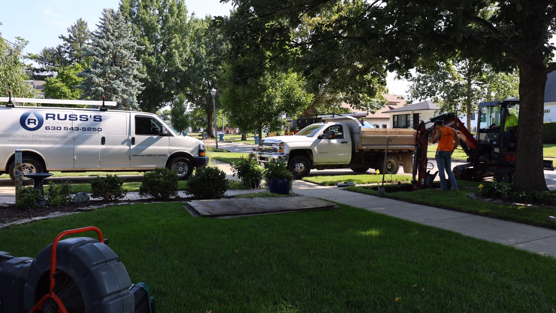 russ-plumbing-white-work-trucks-in-elmhurst-sewer-project