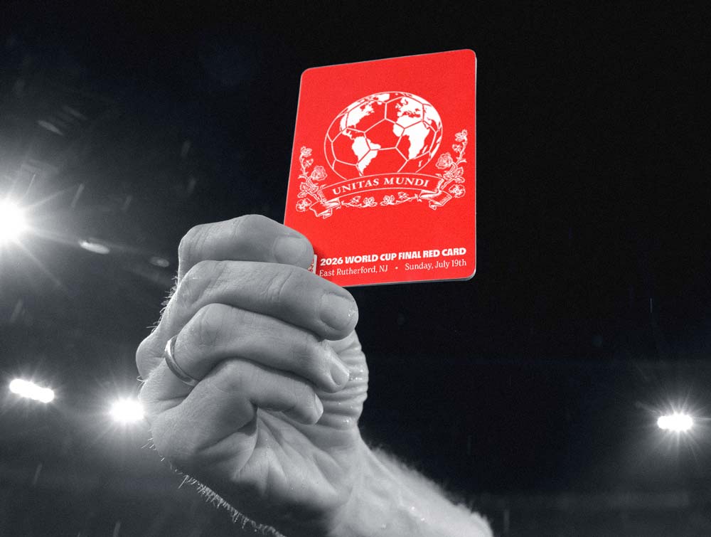 Hand holds a red World Cup red card with a soccer ball globe and text against a dark stadium background.