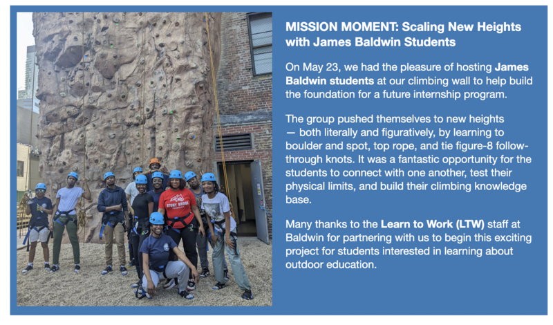 James Baldwin students in blue helmets posing at outdoor climbing wall
