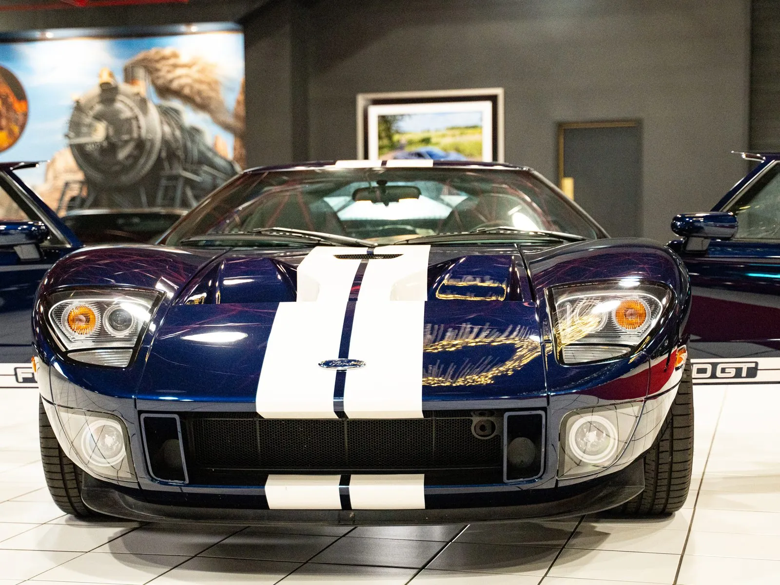 A 2005 Ford GT in dark blue with white racing stripes