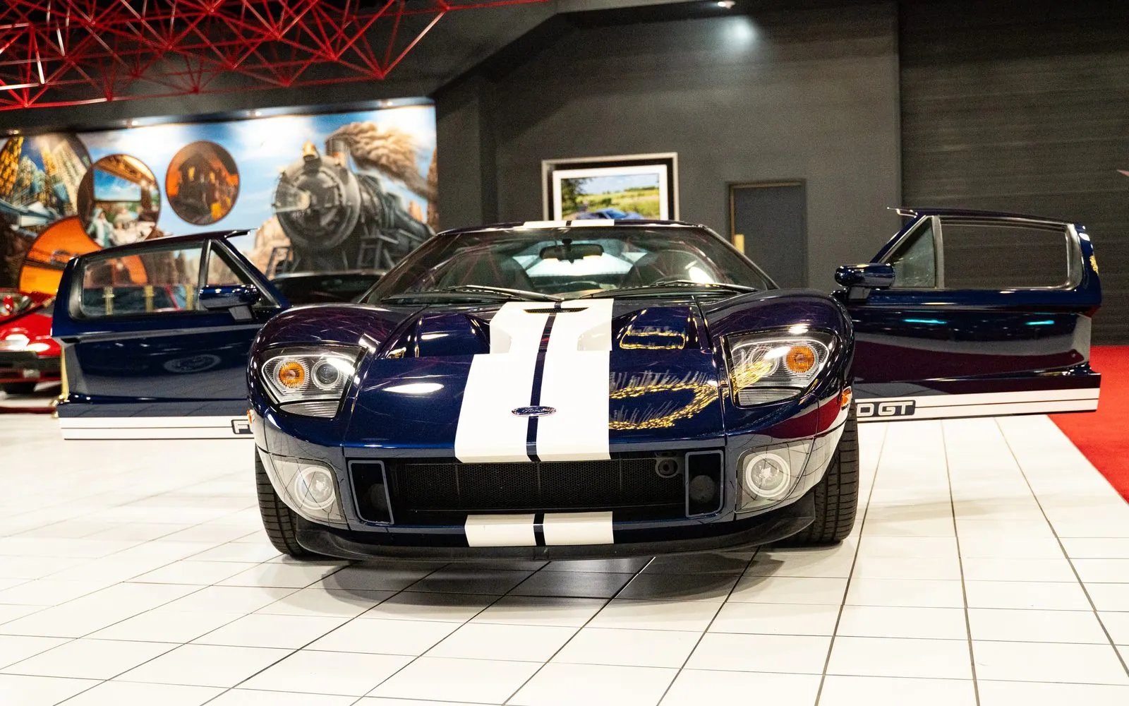 A 2005 Ford GT in dark blue with white racing stripes