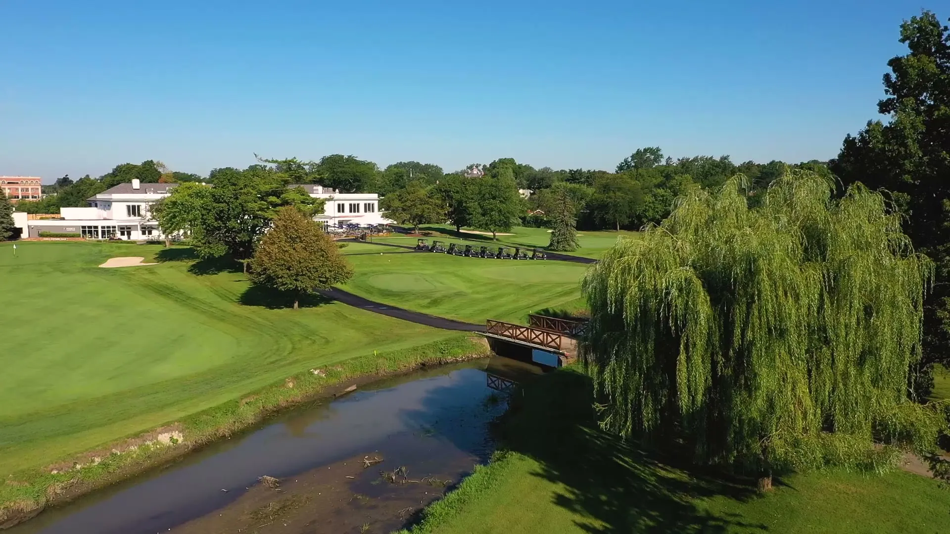 An aerial view of Itasca Country Club's fairways, bridge and clubhouse
