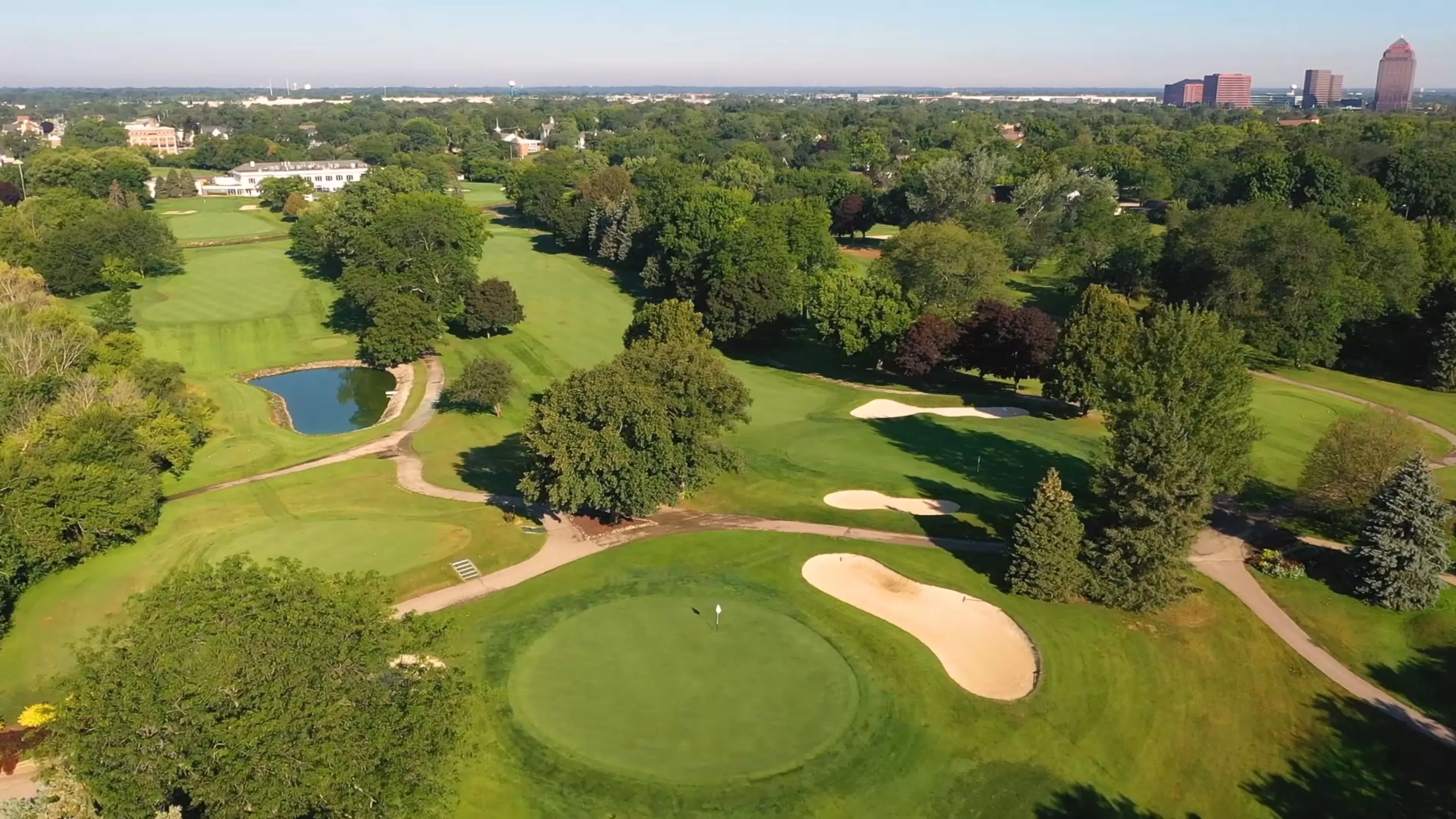 Aerial view of the tree-lined fairways and greens at Itasca Country Club