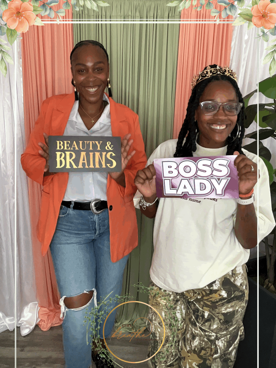 Two smiling women holding signs: one says Beauty & Brains, the other Boss Lady with floral border above.