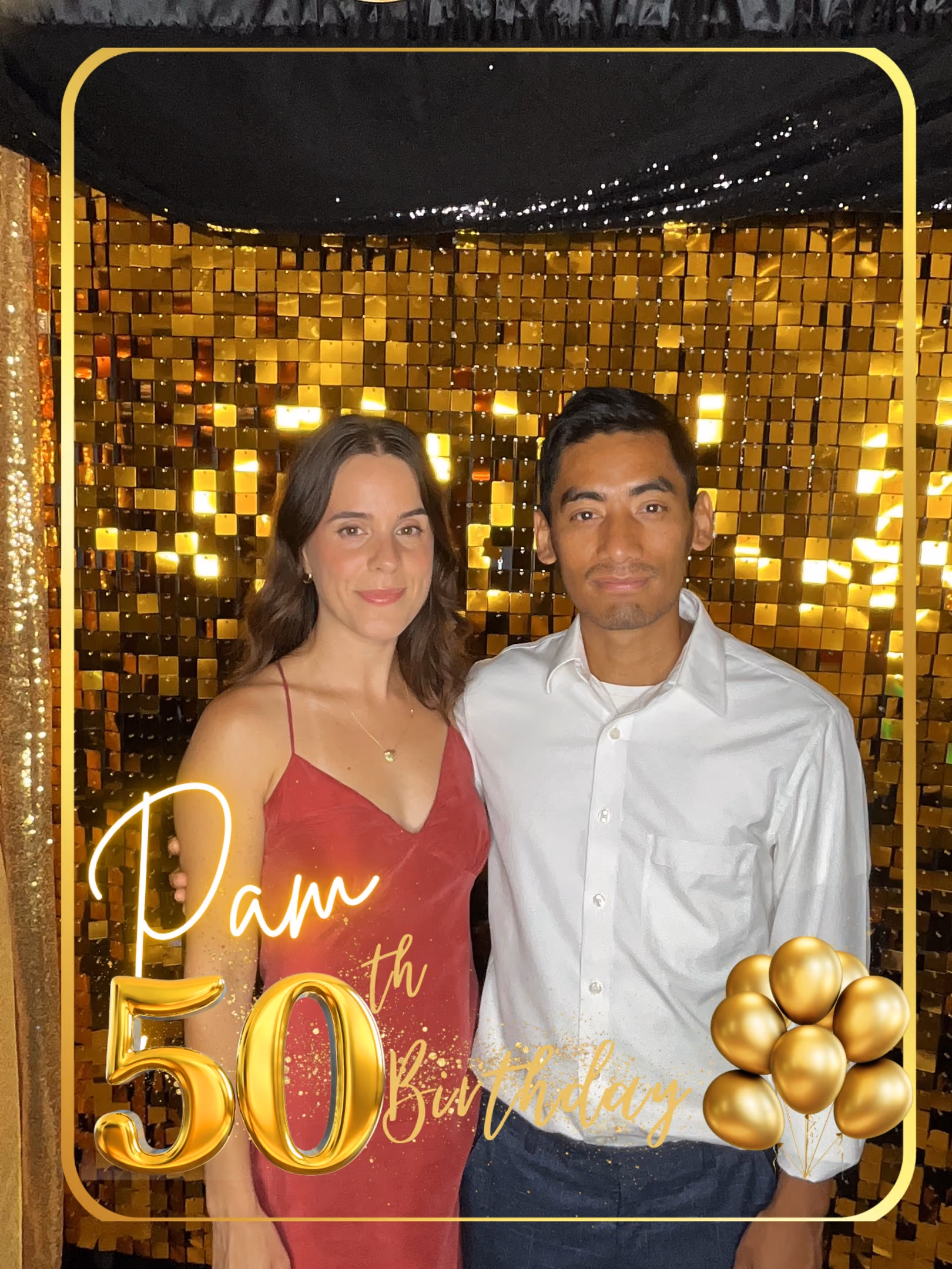 Woman in red dress and man in white shirt standing in front of gold sequin backdrop.