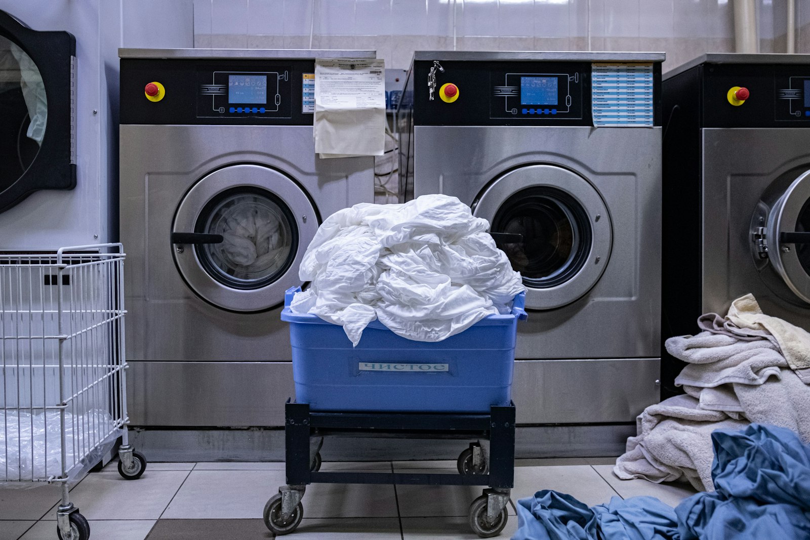 A laundry room with a washing machine and a laundry basket