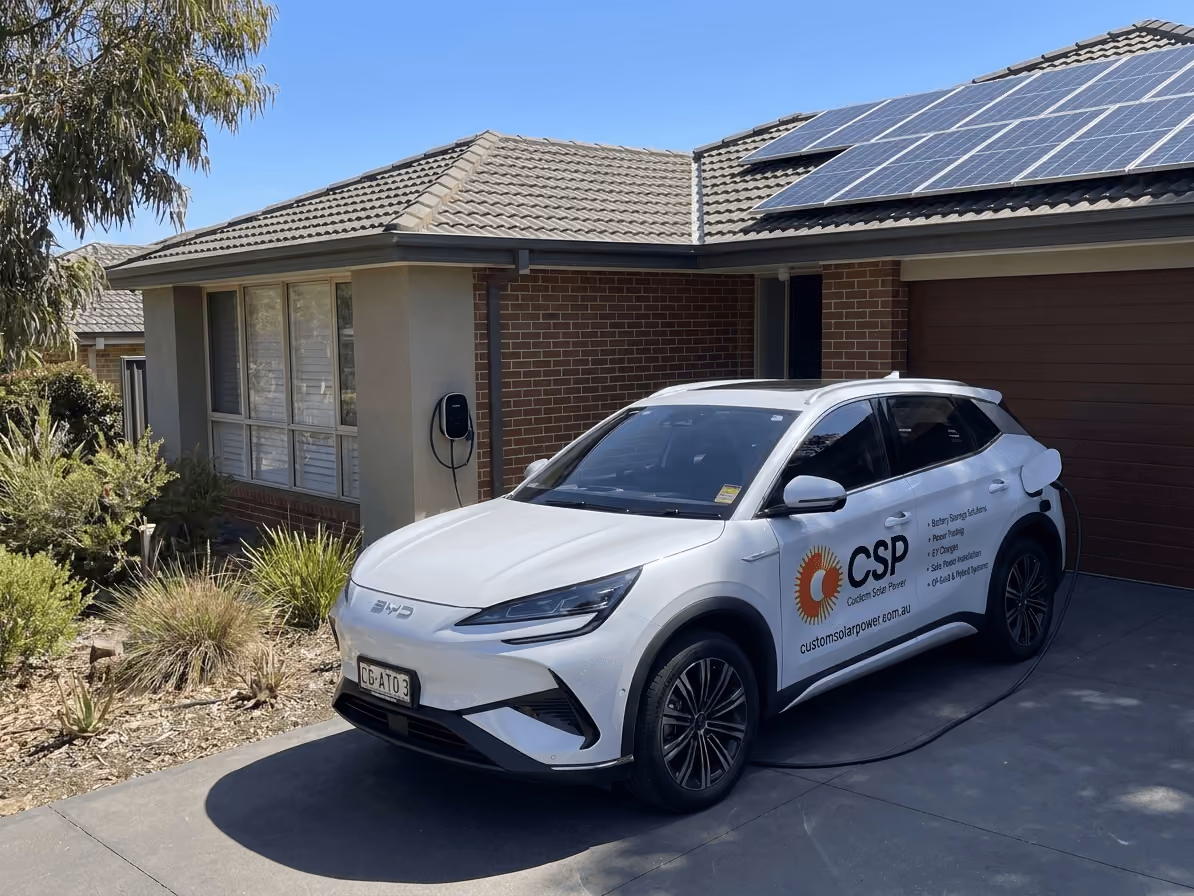 Charging from your own sun - Electric vehicle charging at an Australian home using a wall-mounted EV charger, with rooftop solar panels visible.