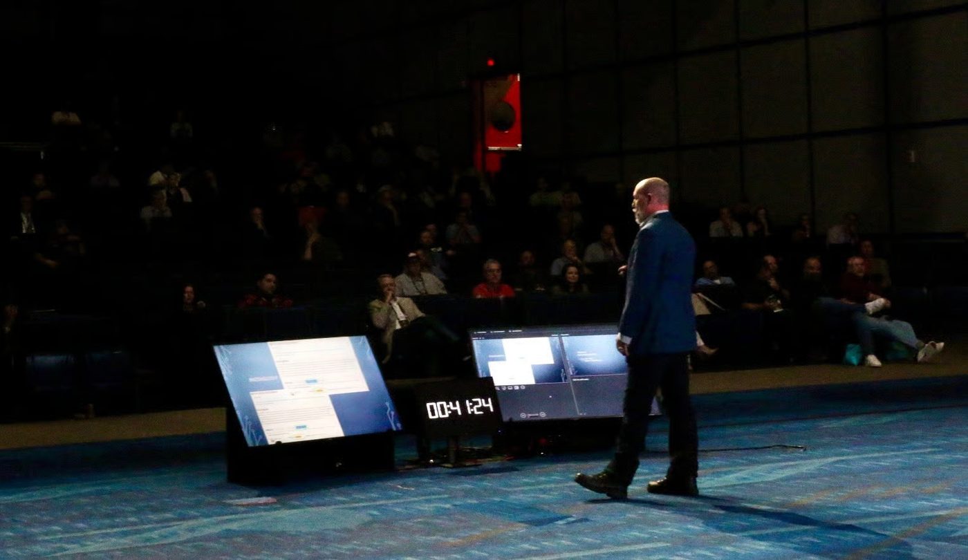 Robert Hansen speaking on stage