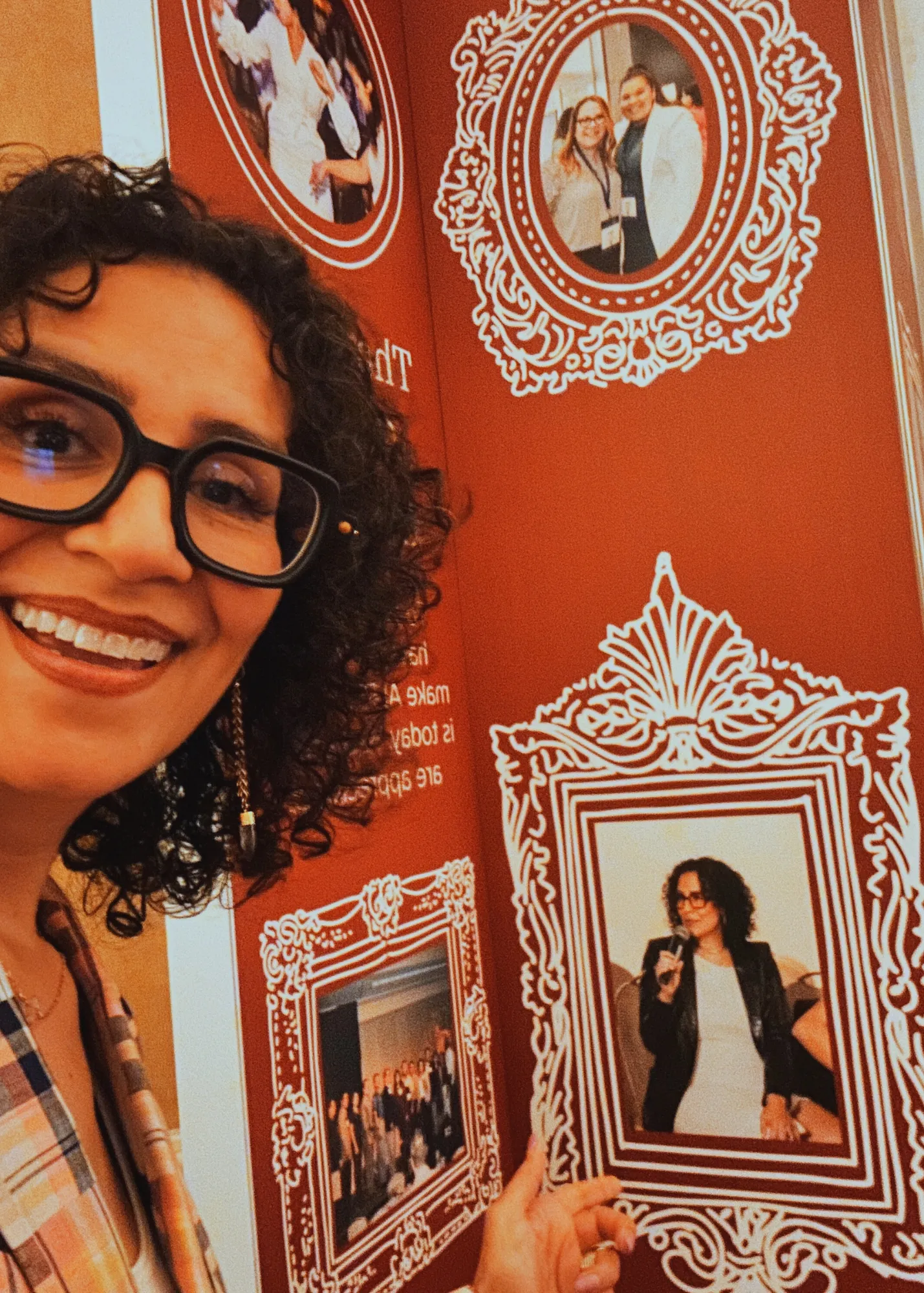 Monica Marquez with a gallery wall of framed photos
