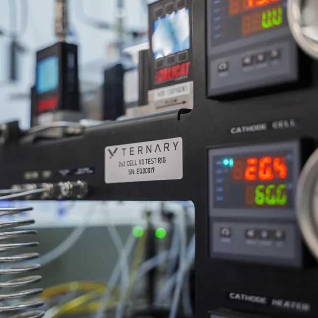 Close-up of Ternary 2x2 Cell V3 Test Rig with digital displays showing voltage and current readings.