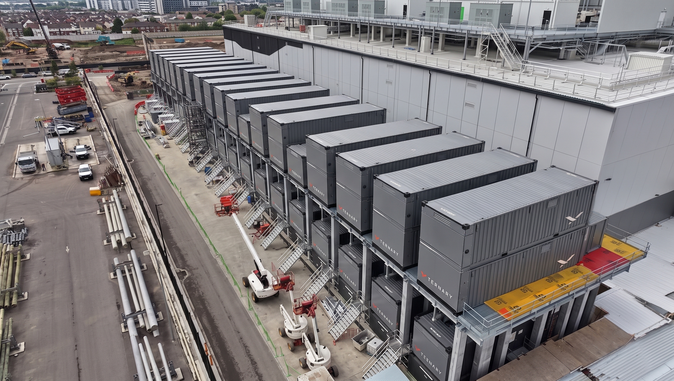 Rows of stacked Ternary converter containers alongside a data center building.