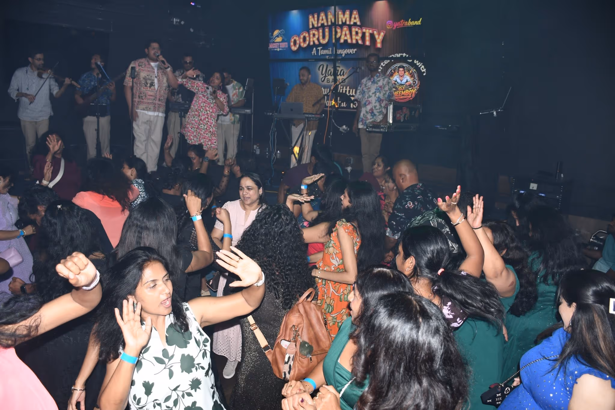 A group of people dancing at a party.