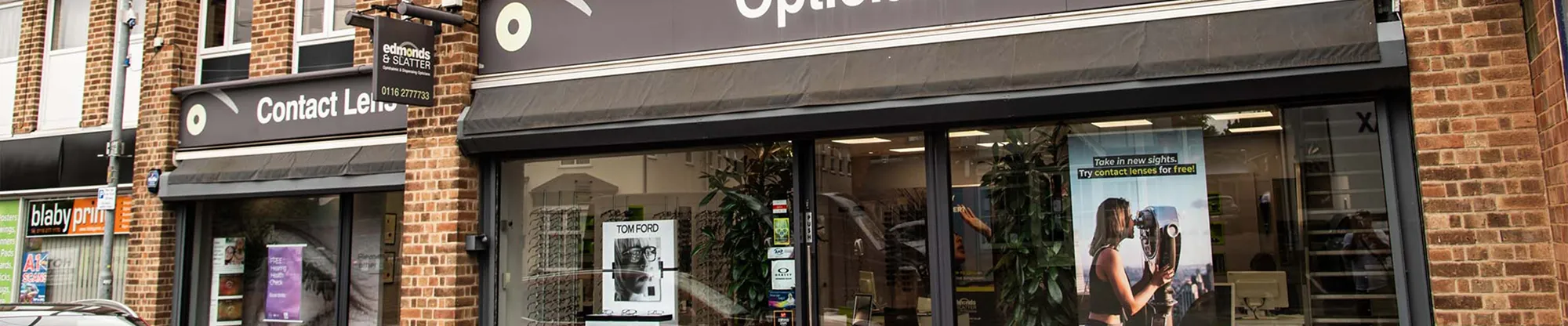 Shopfront of Edmonds & Slatter Opticians with window displays and eyewear signage