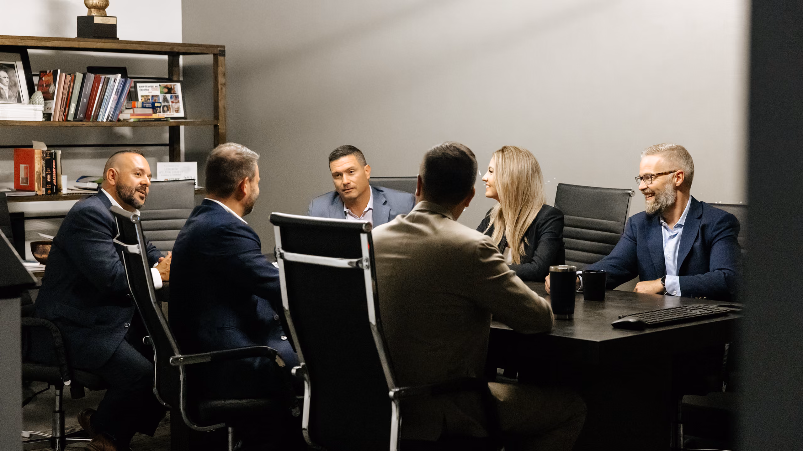 Paideia Solutions Group team meeting around a conference table