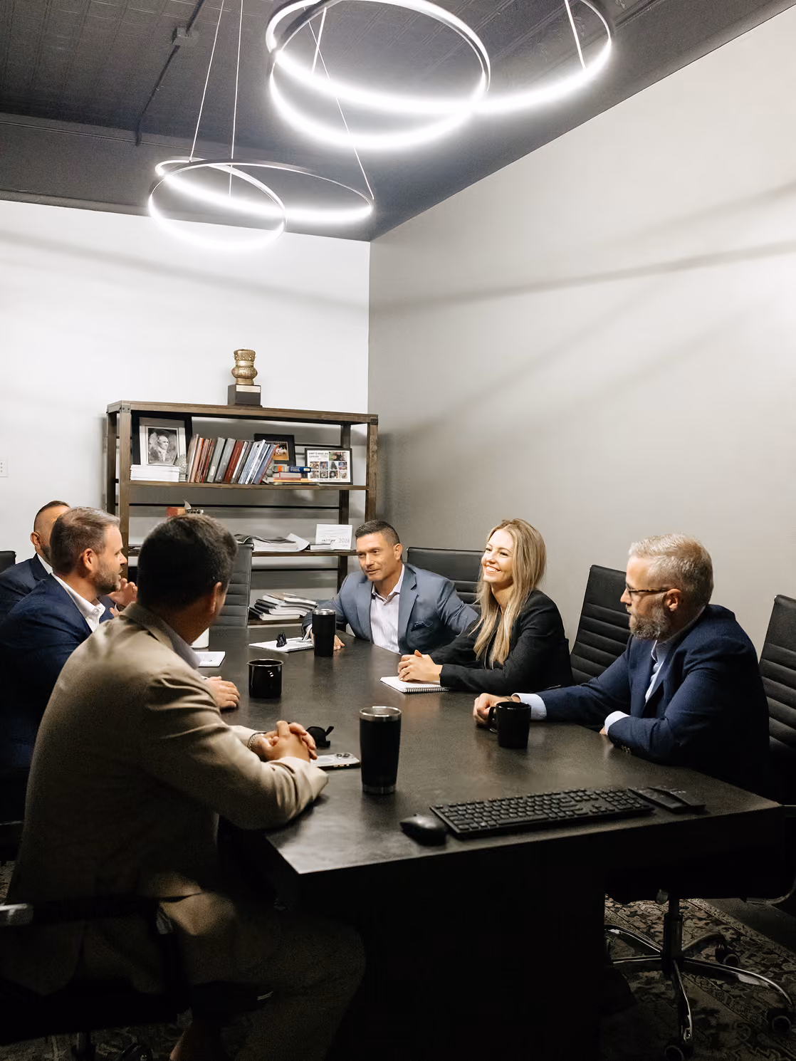 Paideia Solutions Group leadership team meeting around a conference table