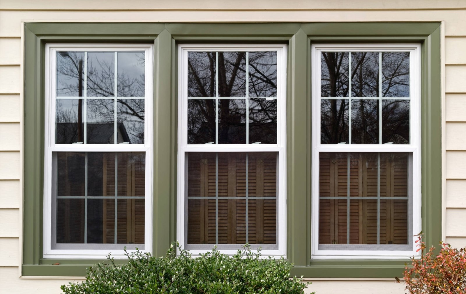 Triple double-hung replacement windows with clean exterior trim by Impact Exteriors