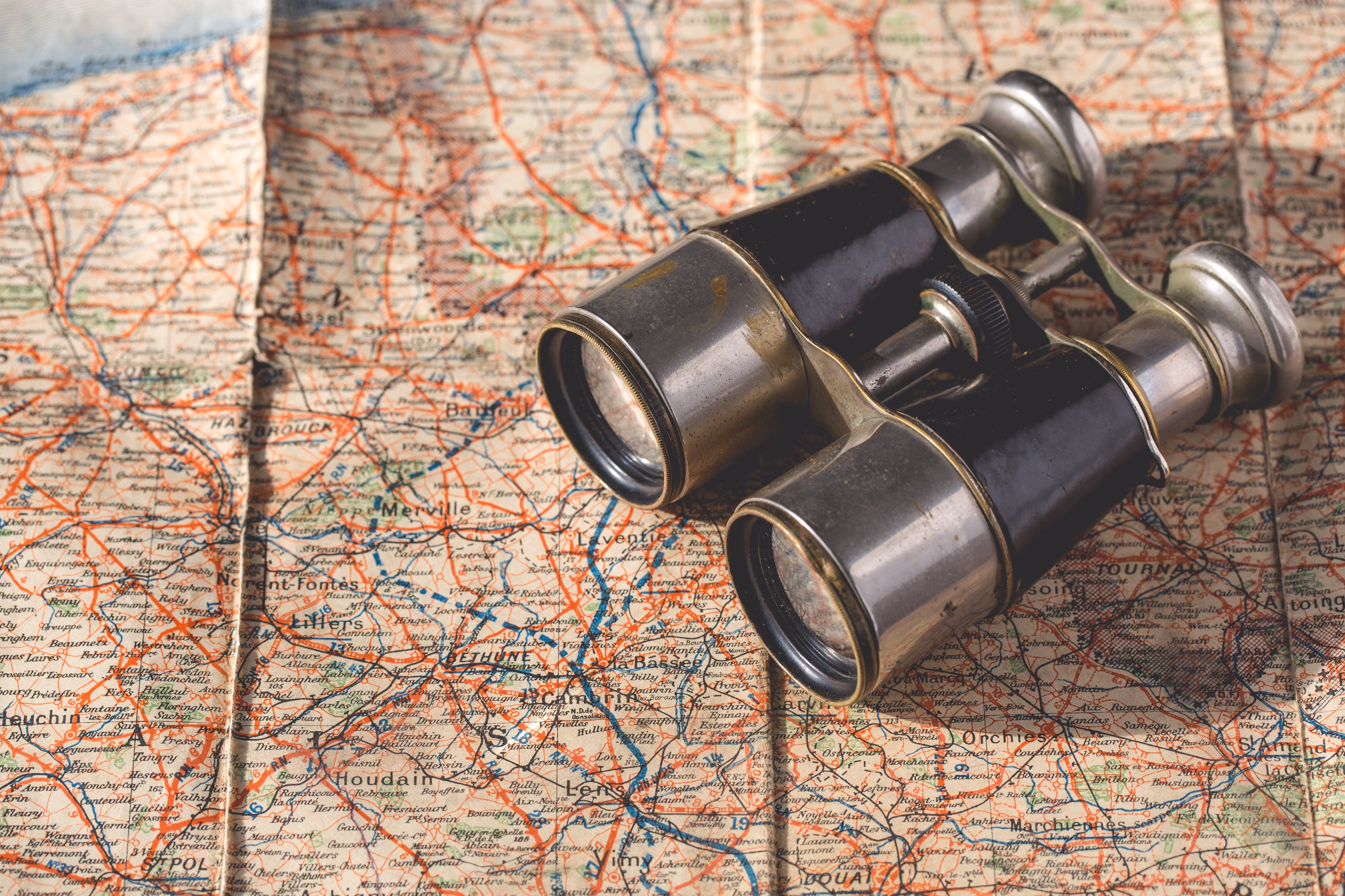 Website growth strategy research: vintage binoculars resting on a paper map