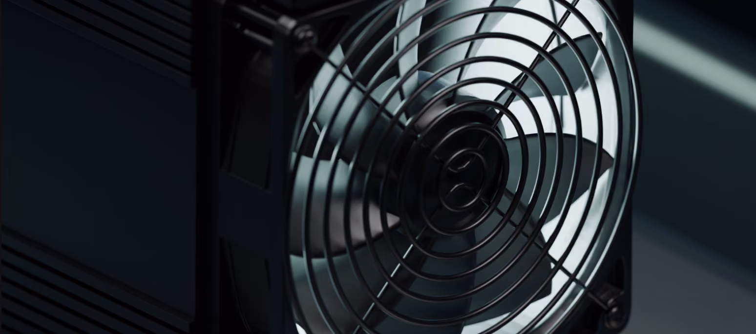 Close-up of a black fan with metal grille and visible blades.