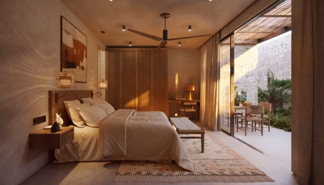 Villa Laga hotel suite bedroom with glass doors opening to a private garden terrace